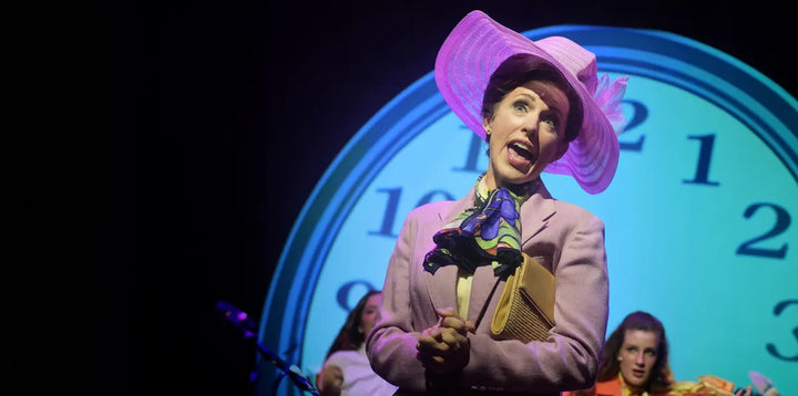 A performer in a pink hat sings a solo