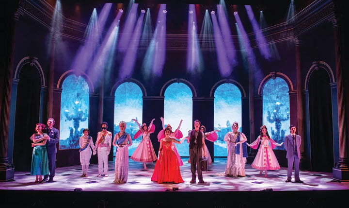 Projected palace windows behind a full cast